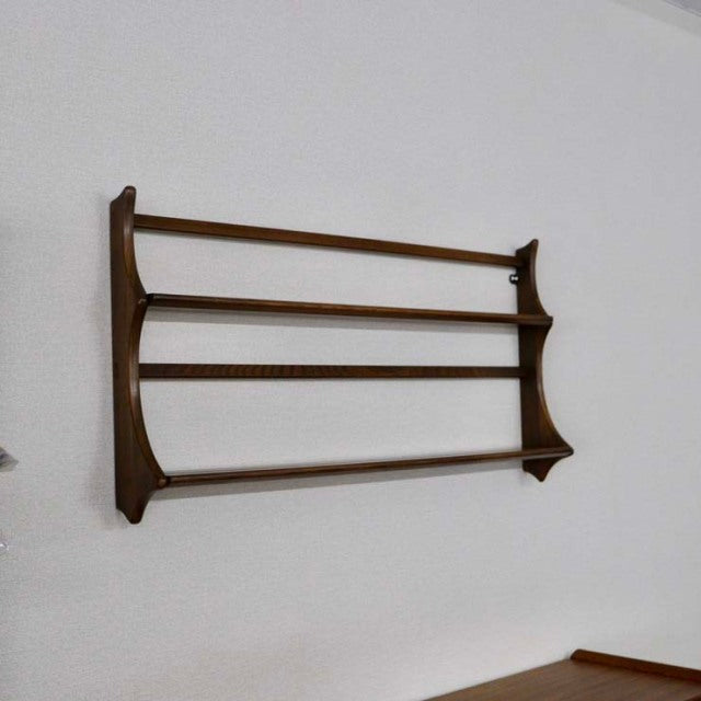 Mid-century British vintage teak Arco l plate rack with smooth wood grain and sleek horizontal bars mounted on wall.
