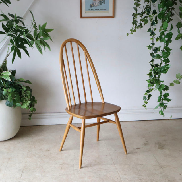 Arcol vintage teak dining chair with curved spindle back, tapered legs, and mid-century British design, set against white.