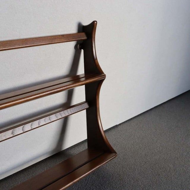 Vintage British mid-century Ercol teak wall-mounted plate rack with visible wood grain and curved side supports.