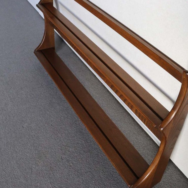 Vintage British mid-century teak Ercol plate rack with smooth wood grain and elegant curved supports.
