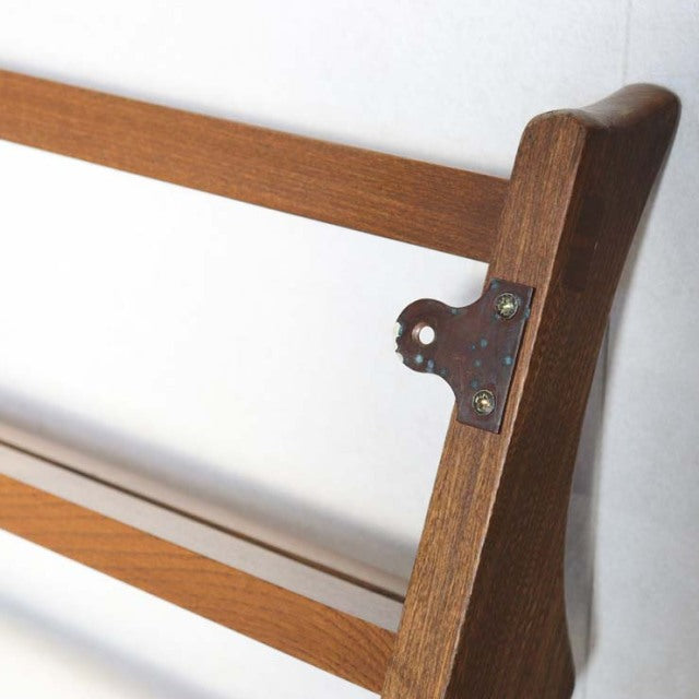 Vintage British mid-century teak Ercol plate rack with smooth wood grain and brass mounting bracket.