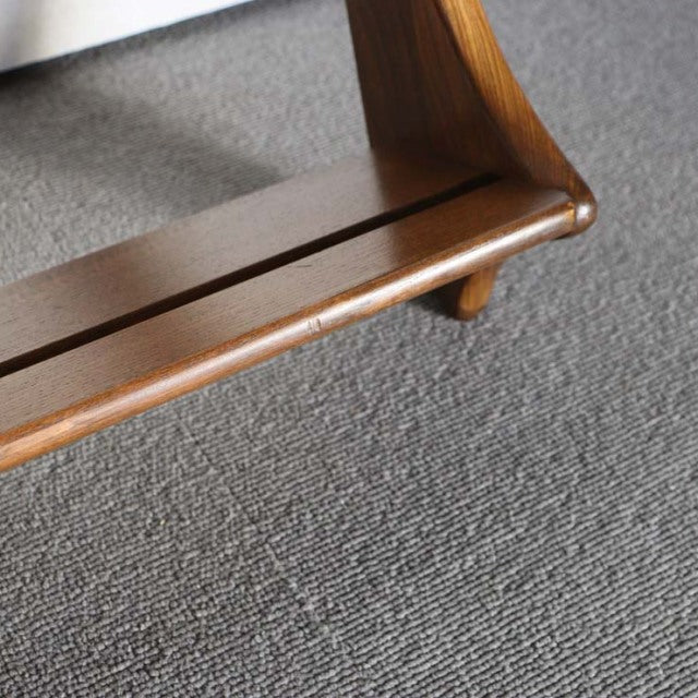 Vintage British teak Ercol plate rack corner with smooth wood grain and rounded leg detail.