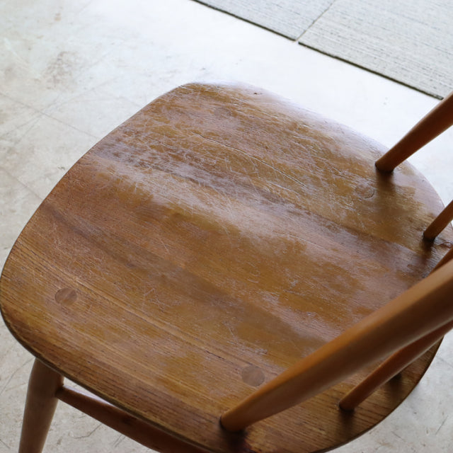 Vintage teak mid-century British Ercol Quaker chair seat showing warm wood grain and smooth finish.