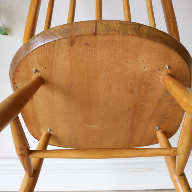 Vintage British mid-century Ercol Quaker chair in natural teak, showing smooth wood grain and tapered legs from Denmark.