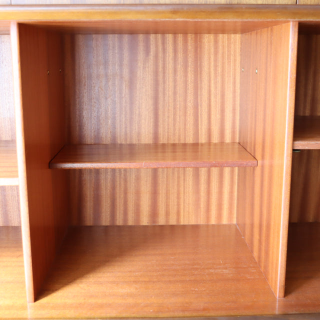 Vintage G-Plan teak sideboard shelving compartment showing rich wood grain and mid-century British design details.