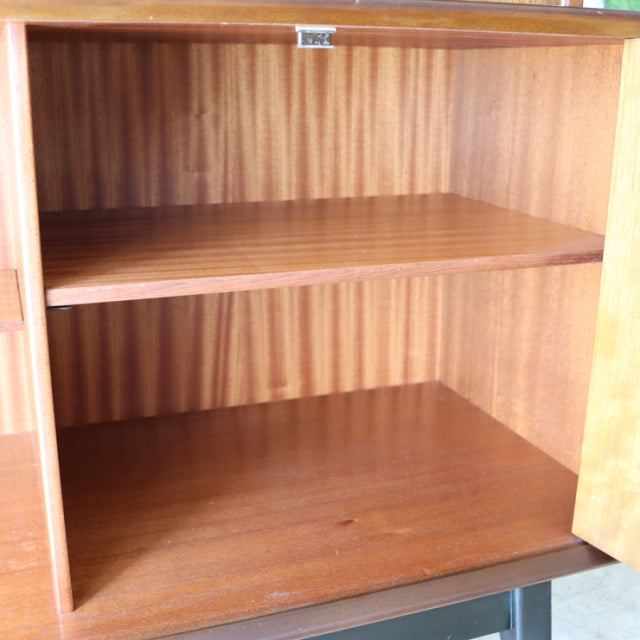 Open mid-century teak sideboard interior with visible wood grain shelves, British vintage design by G-Plan.