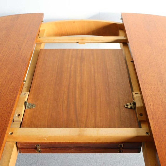 Mid-century vintage teak dining table with expansion leaf, smooth wood grain and sturdy wooden frame from British Danish.