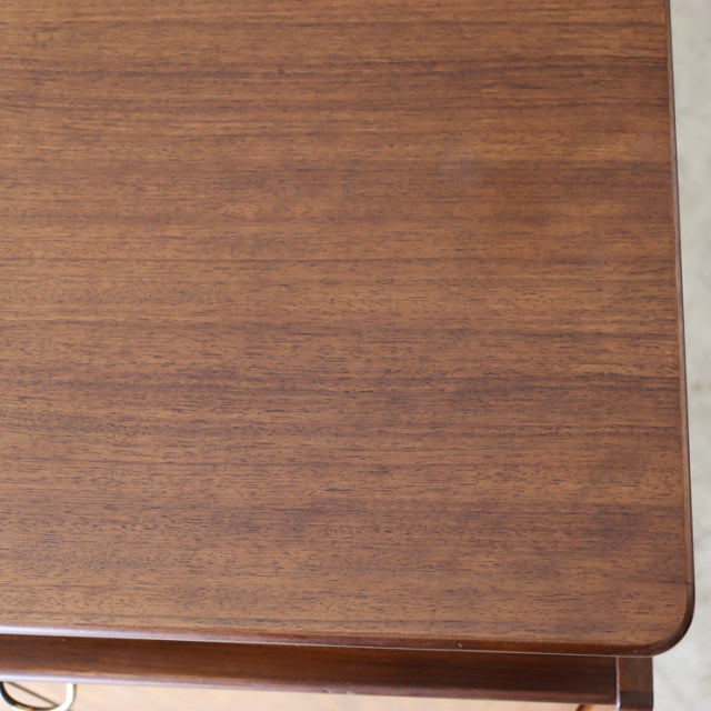 Close-up of vintage British mid-century G-Plan teak sideboard corner with smooth wood grain and rounded edges.