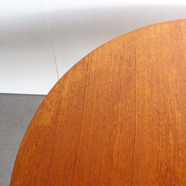 Oval mid-century British vintage teak dining table top showing rich wood grain and smooth finish.