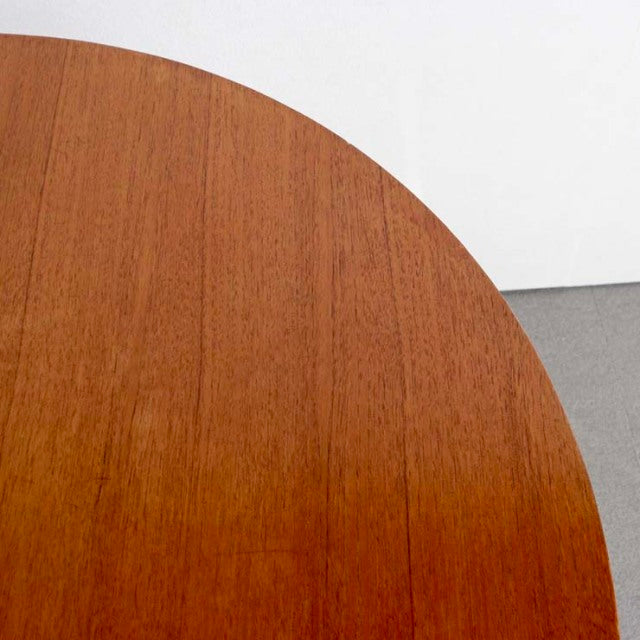 Round vintage teak dining table top with rich wood grain, mid-century British design.