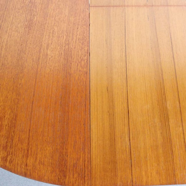 Vintage mid-century British teak dining table top with rich wood grain and warm honey tones.
