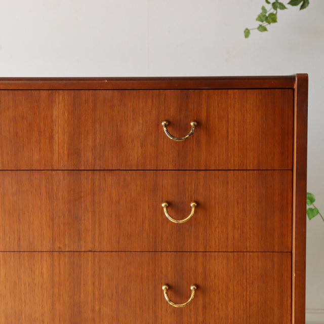 Mid-century British G-plan teak chest with four drawers, brass handles, and clean wood grain finish.