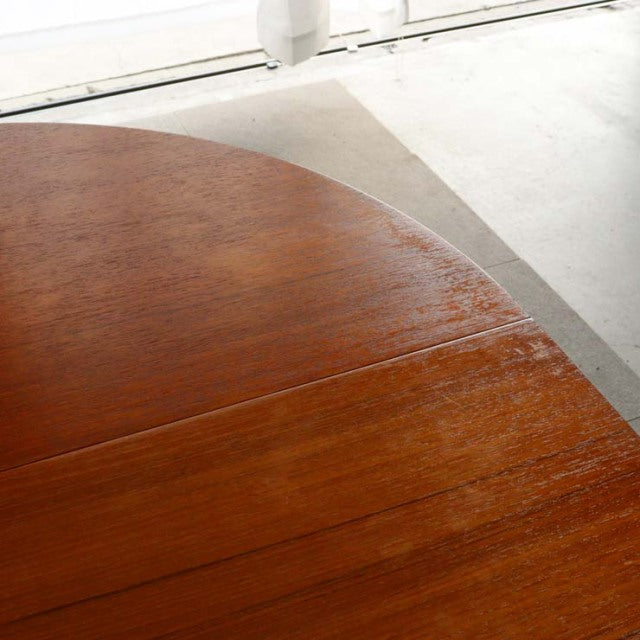 Vintage teak dining table top with rich wood grain and warm mid-century British design details.