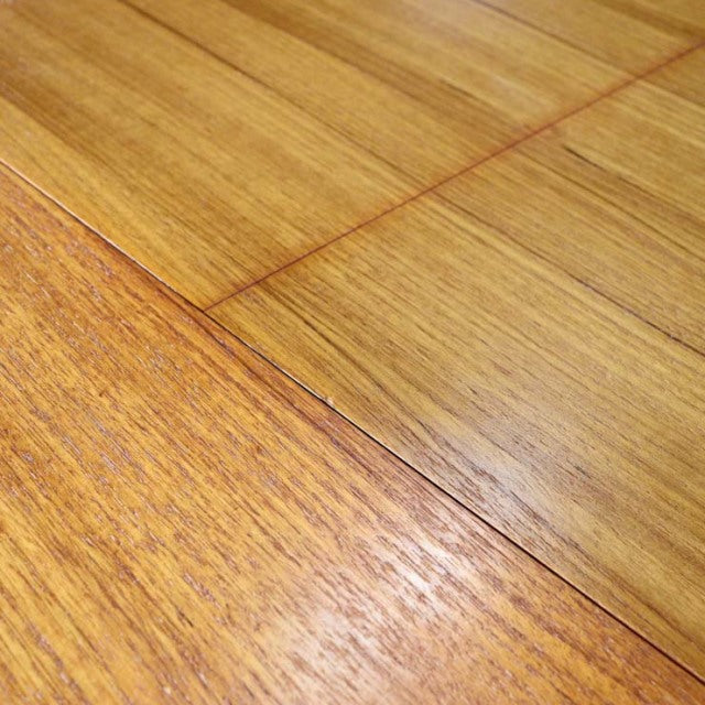 Close-up of vintage British mid-century teak dining table top showing rich wood grain and smooth finish.