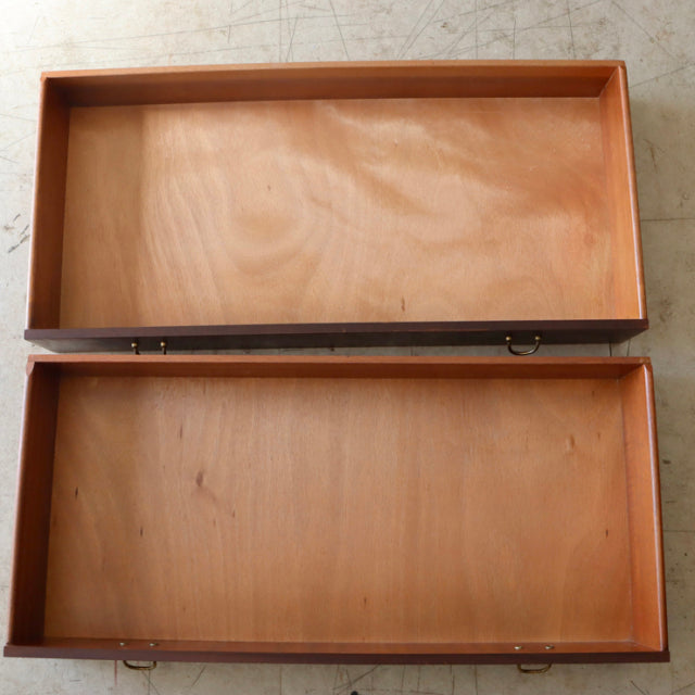 Open teak drawers from vintage British mid-century G-Plan chest showing smooth wood grain and clean interior panels.