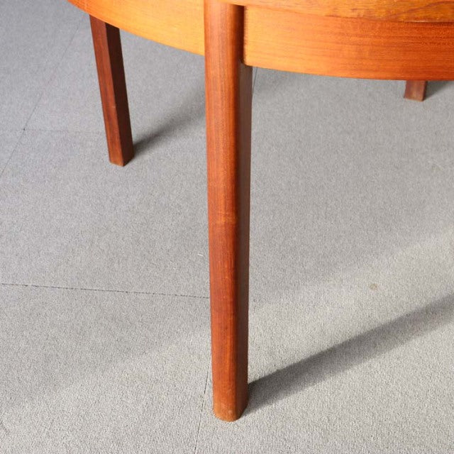 Mid-century British vintage teak dining table leg with smooth grain and tapered design.