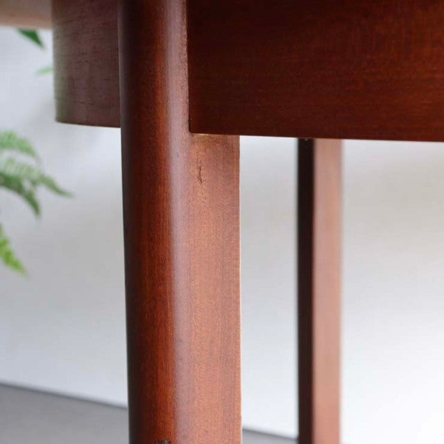 Mid-century British vintage teak dining table leg with smooth wood grain and warm brown finish.