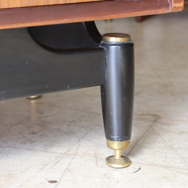 Mid-century black tapered wooden leg with brass cap and adjustable teak floor glide on vintage British G-plan chest.