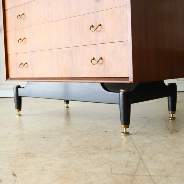 Vintage G-Plan mid-century teak chest with black tapered legs and brass-capped feet, British-Denmark design.