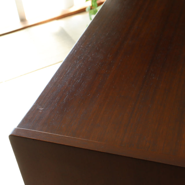 Close-up of G-Plan vintage teak sideboard top showing rich wood grain and warm mid-century British design.
