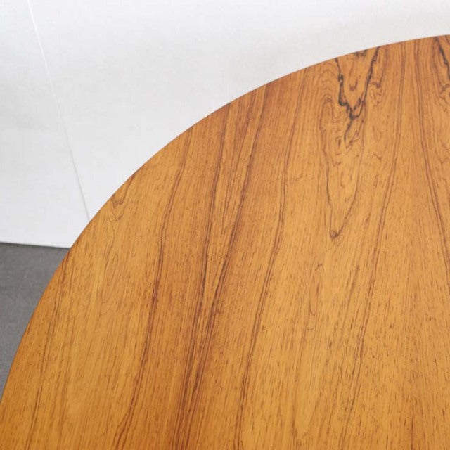 Round mid-century British vintage teak dining table top with warm wood grain and smooth finish.