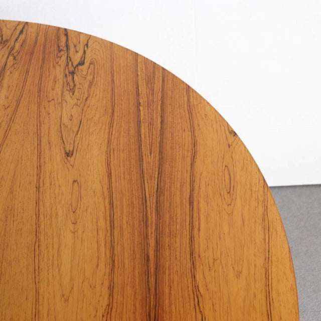 Round vintage teak dining table top with rich wood grain showcasing mid-century British design influences.