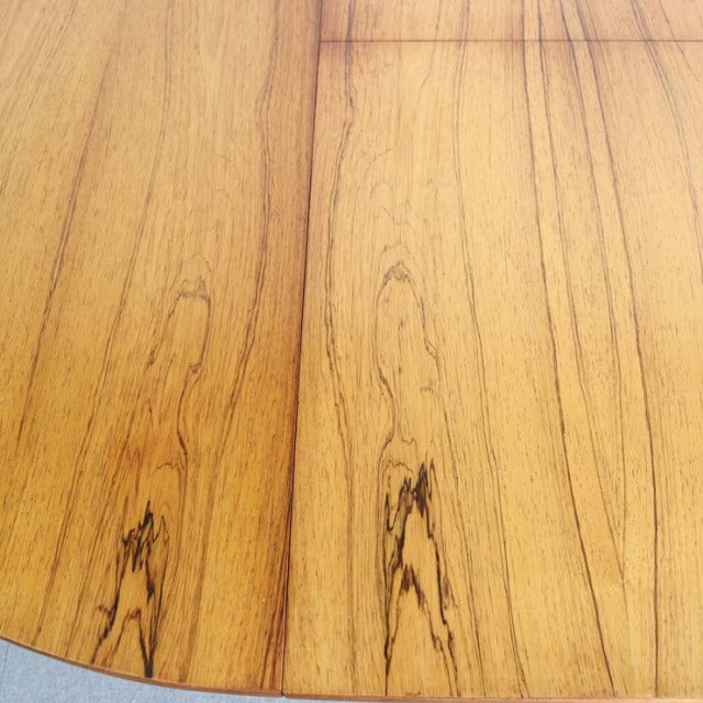 Round vintage teak dining table top with visible grain patterns, smooth finish, British mid-century design.