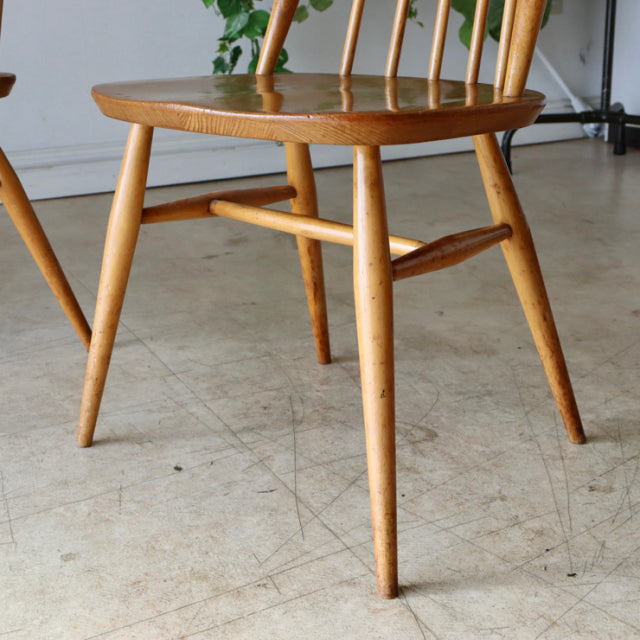 Vintage British Ercol Goldsmith teak high-back dining chair with tapered legs and spindle back in natural finish.