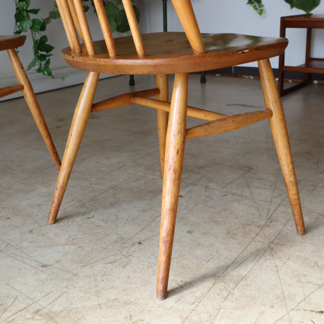 Vintage British mid-century Ercol Goldsmith highback teak dining chair with tapered legs and visible wood grain.