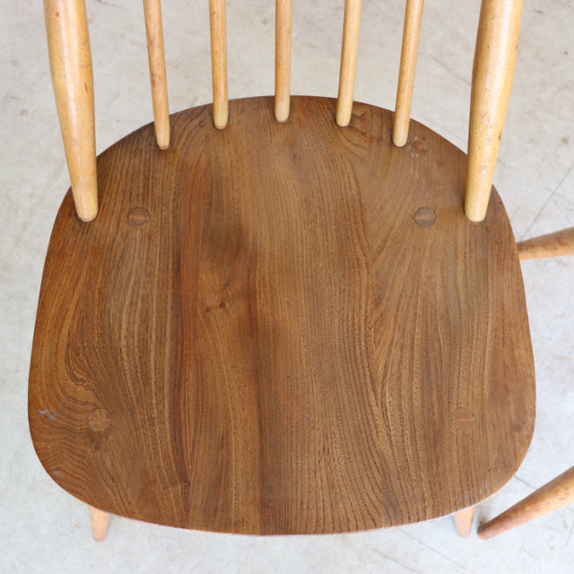Set of four Arcol Goldsmith mid-century British teak dining chairs in natural finish with smooth contoured seats and slender .