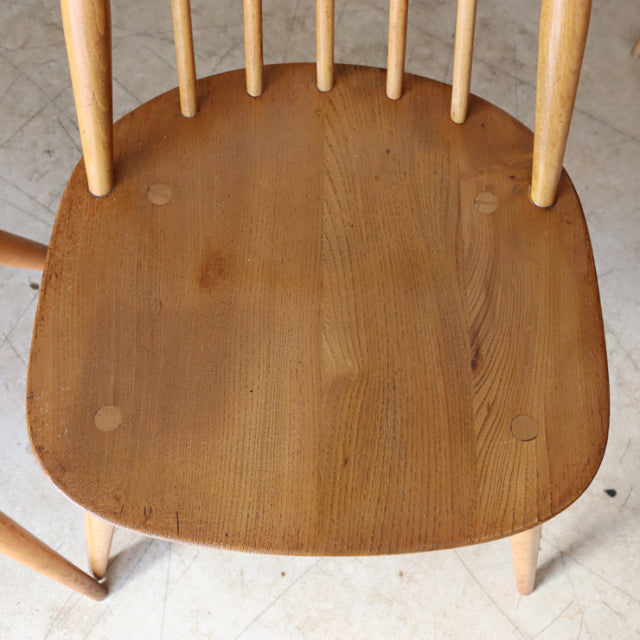 Vintage British mid-century Ercol Goldsmith teak chair seat showing wood grain and rounded edges with spindle backrest legs.