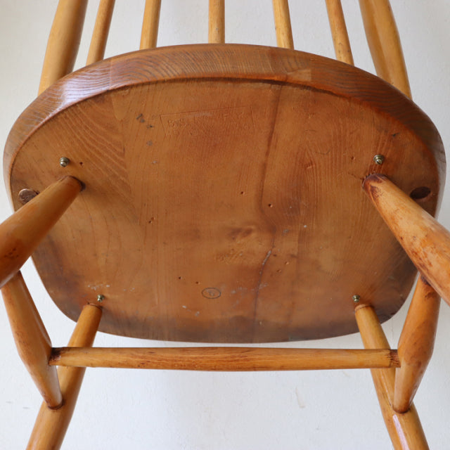 Vintage Ercol Goldsmith mid-century teak dining chair seat underside showing rich wood grain and sturdy turned legs.