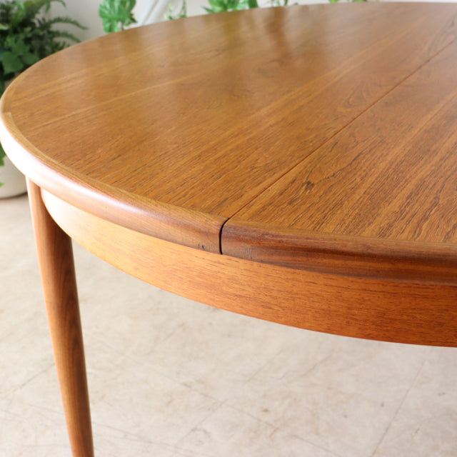 Vintage British G-Plan mid-century teak dining table with smooth rounded edge and tapered legs.