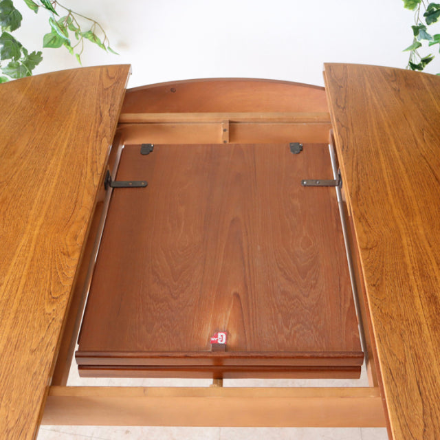 Vintage G-Plan teak mid-century dining table with oval leaves and wood grain detail.
