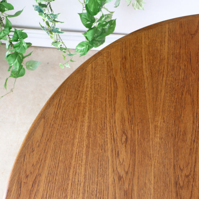 Vintage British G-Plan teak dining table with smooth oval top showcasing rich wood grain and mid-century design.