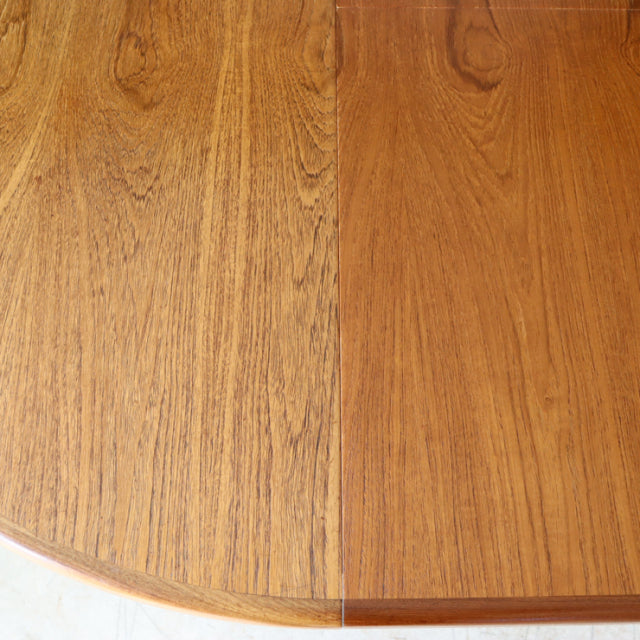 Oval vintage teak dining table top showing rich wood grain and smooth finish from British mid-century G-Plan design.