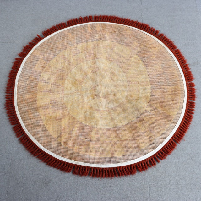 Round vintage teak rug with rich wood grain and natural mid-century British design, featuring deep red fringed edge and.