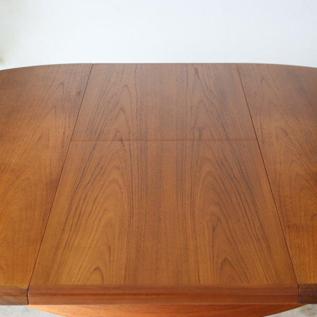 Round mid-century vintage teak dining table by British G-Plan with rich wood grain and smooth edges.
