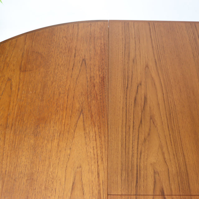 Mid-century British G-Plan round dining table in vintage teak with visible wood grain and smooth finish.