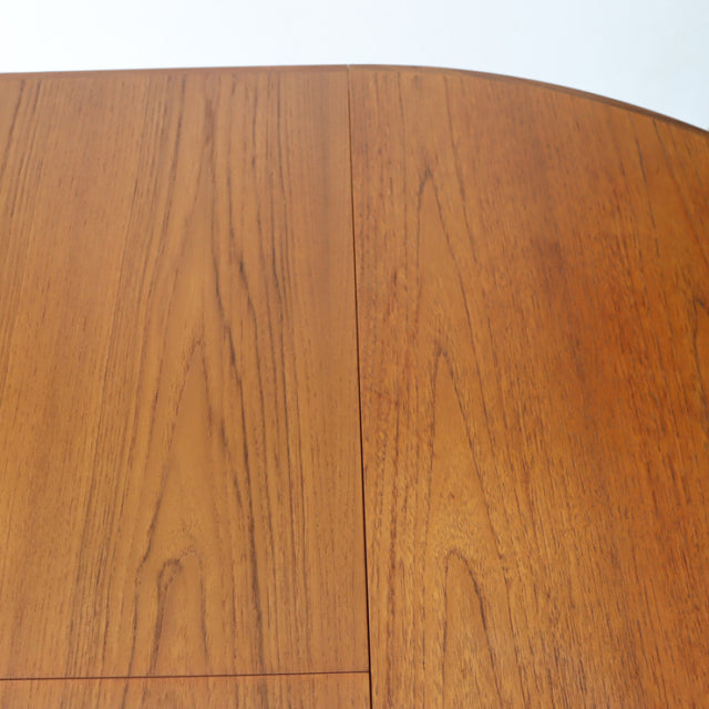 Mid-century British G-plan vintage teak round dining table top showcasing rich wood grain and smooth finish.