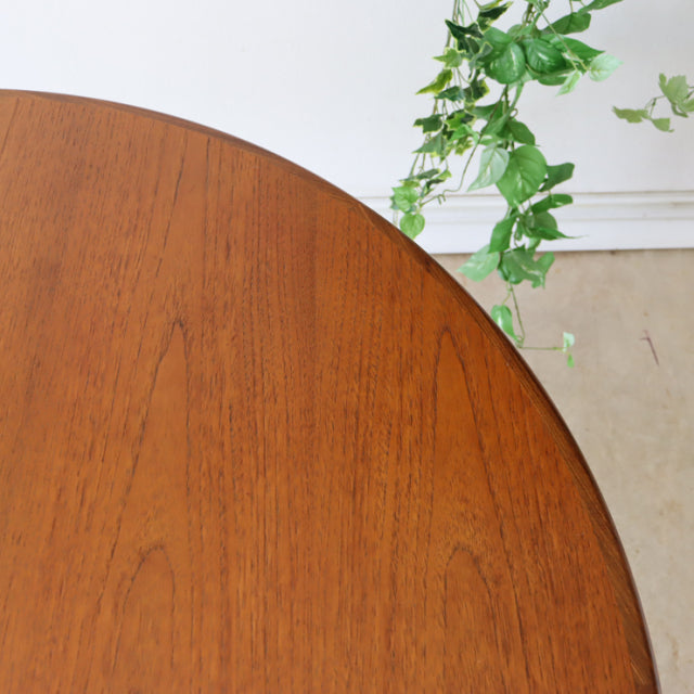 Vintage mid-century British G-Plan round dining table in rich teak with smooth wood grain and rounded edge.