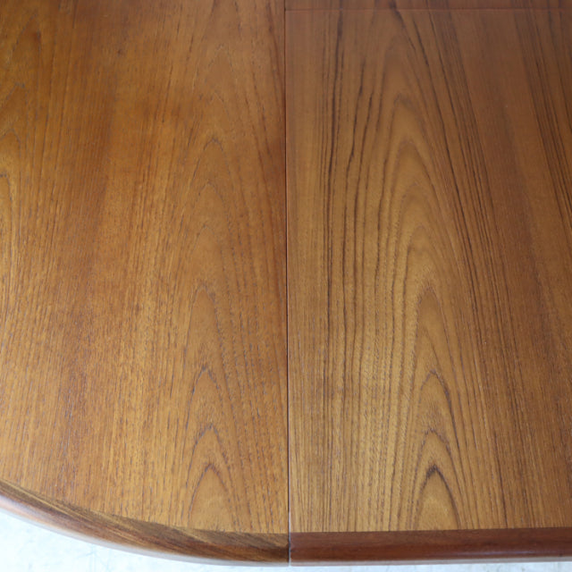 Vintage teak round dining table top with visible wood grain and smooth polished mid-century British design from G-plan.