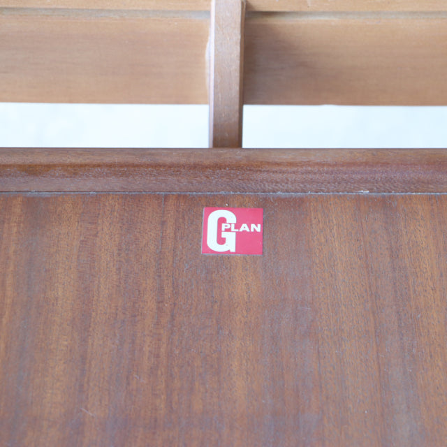 Close-up of vintage G-Plan teak dining table showcasing rich wood grain and British mid-century brand label.
