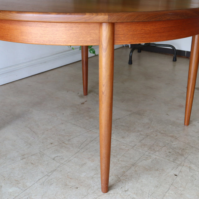 Vintage G-PLAN mid-century teak round dining table with tapered legs and smooth wood grain.
