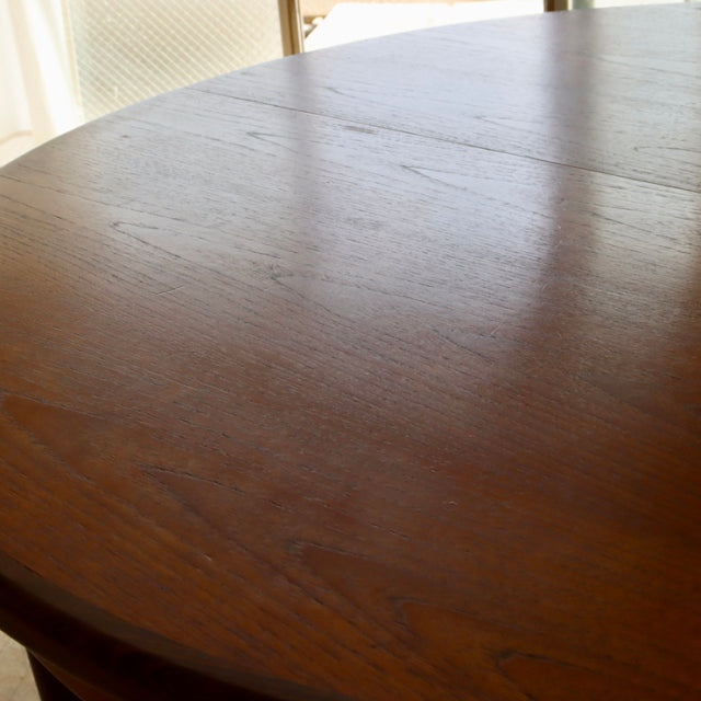 Round vintage teak dining table by British G-PLAN with smooth mid-century wood grain and subtle seamless top joint.