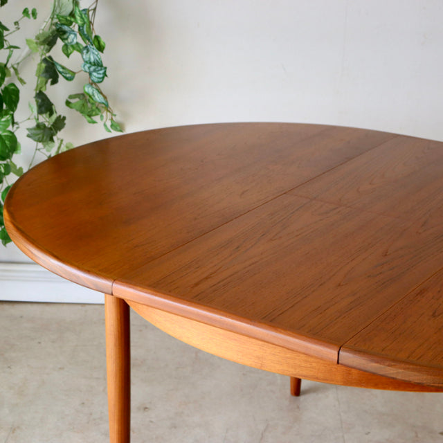 Vintage G-PLAN teak round mid-century dining table with smooth wood grain and tapered legs, British design inspired by.