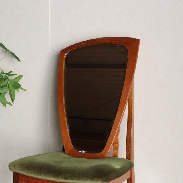 Mid-century vintage teak wall mirror from Denmark with organic pebble-like shape and smooth wood grain.