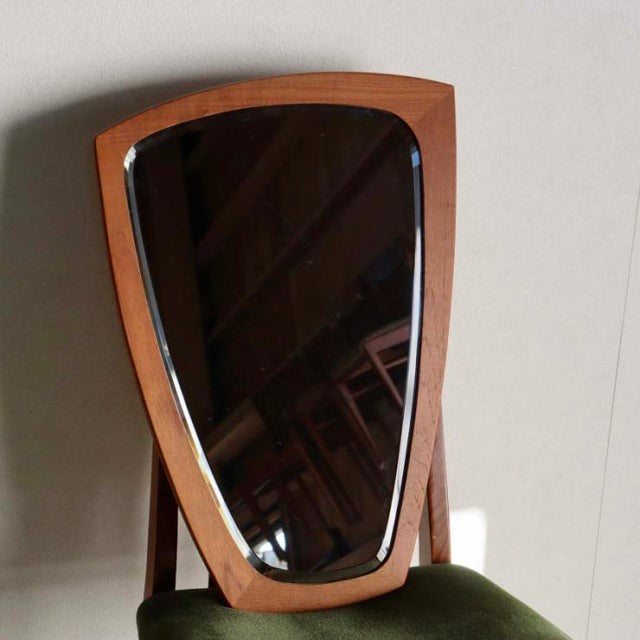 Mid-century Danish vintage wall mirror with teak frame shaped like a smooth river stone, showcasing rich wood grain and warm .