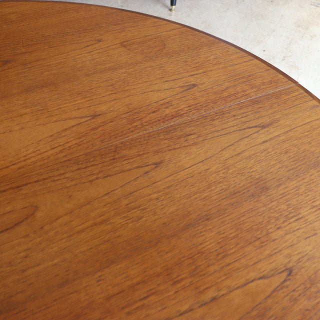 Round vintage teak dining table top showing warm wood grain and smooth finish, British mid-century G-Plan design.