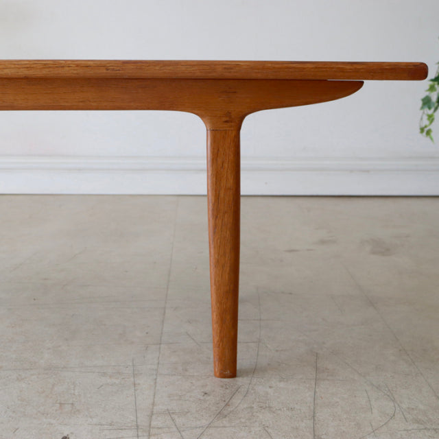 Mid-century vintage teak coffee table leg with smooth wood grain and rounded edges, British-Denmark design.